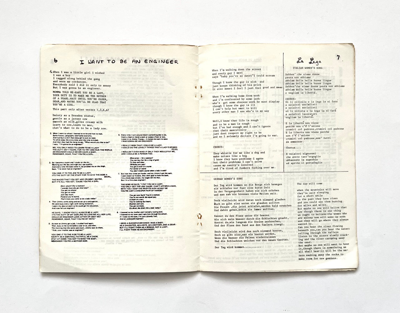 Open 1977 Women's Liberation Conference songbook with two pages of song lyrics.
