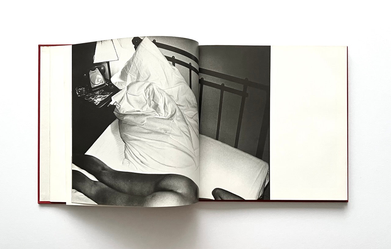 Open David Bailey's Trouble and Strife' book with a black and white photograph of nude Marie Helvin in bed seen from above.