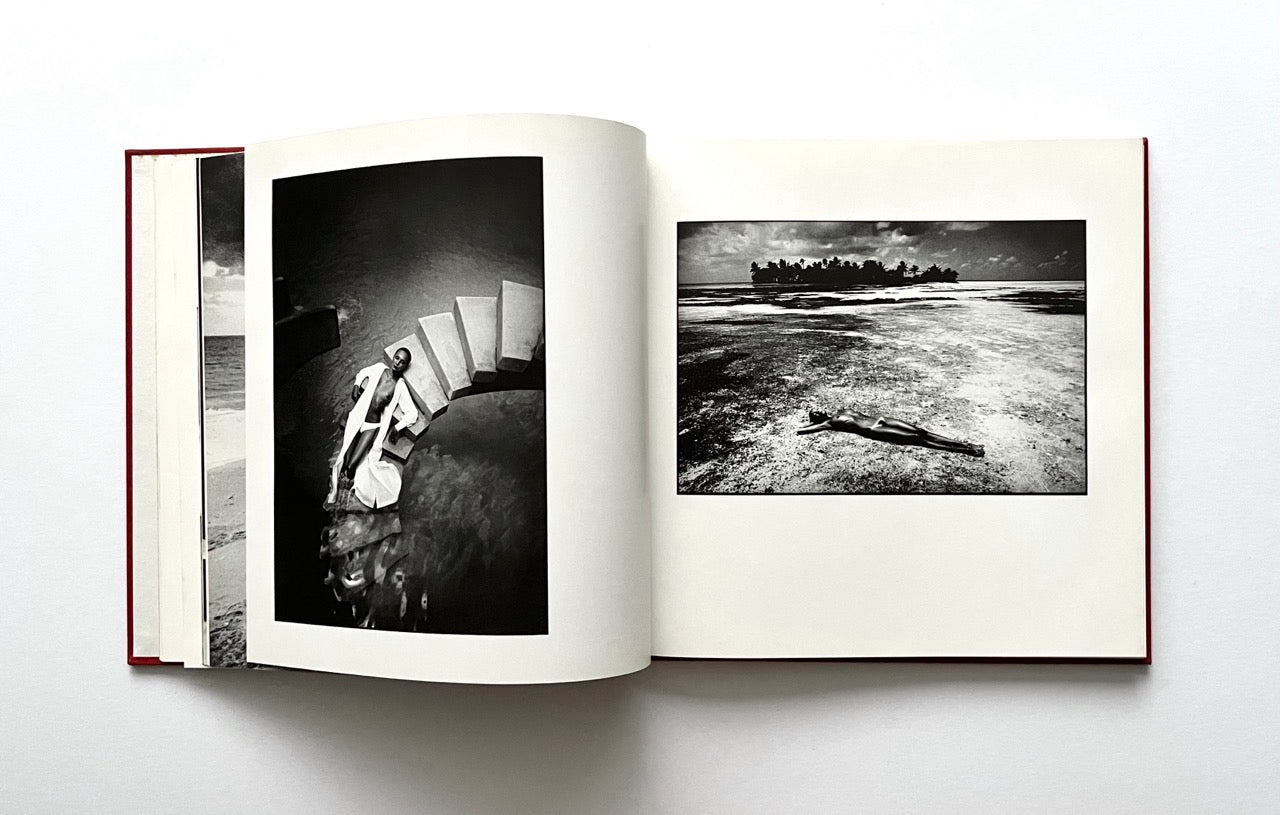 Open David Bailey's Trouble and Strife' book with black and white photographs of nude Marie Helvin on the beach and on the stone staircase.
