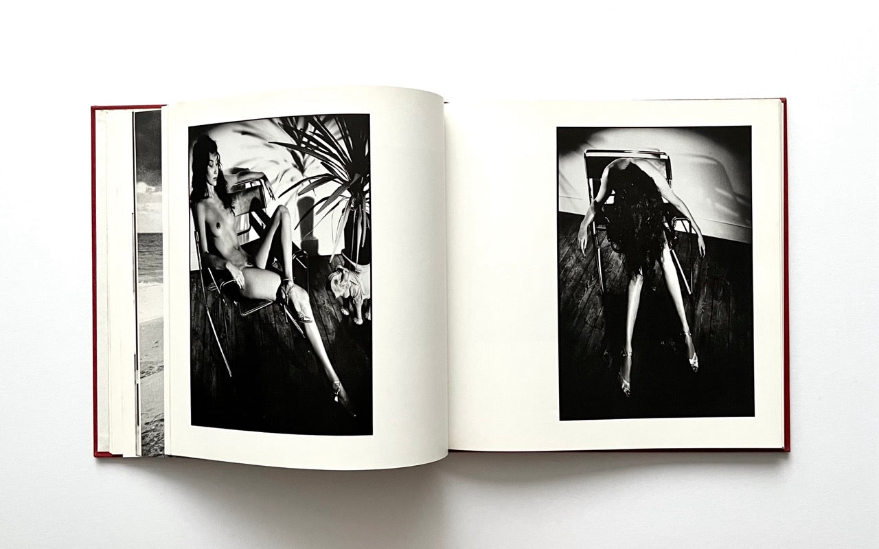 Open David Bailey's Trouble and Strife' book with black and white photographs of nude Marie Helvin sitting in a dramatic pose on a metal chair.