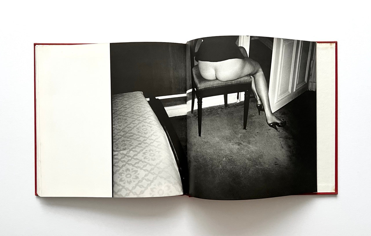 Open David Bailey's Trouble and Strife' book with a black and white photograph of half-nude Marie Helvin sitting on a chair.