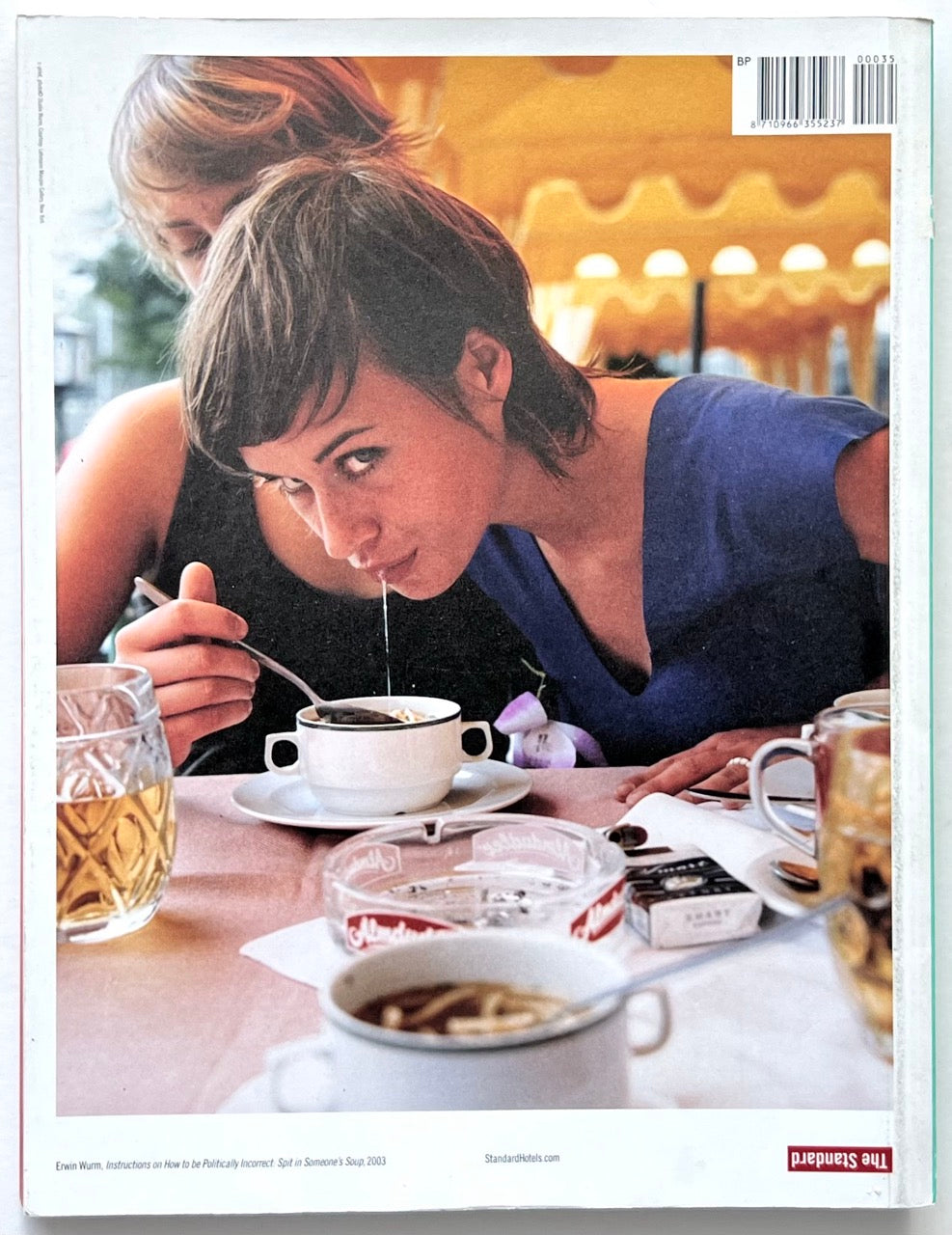 FOAM International Photography Magazine, Issue #35: Lust, Summer 2013. Back cover featuring Erwin Wurm’s photograph Instructions on How to Be Politically Incorrect: Spit in Someone’s Soup (2003), depicting two women at a restaurant table.
