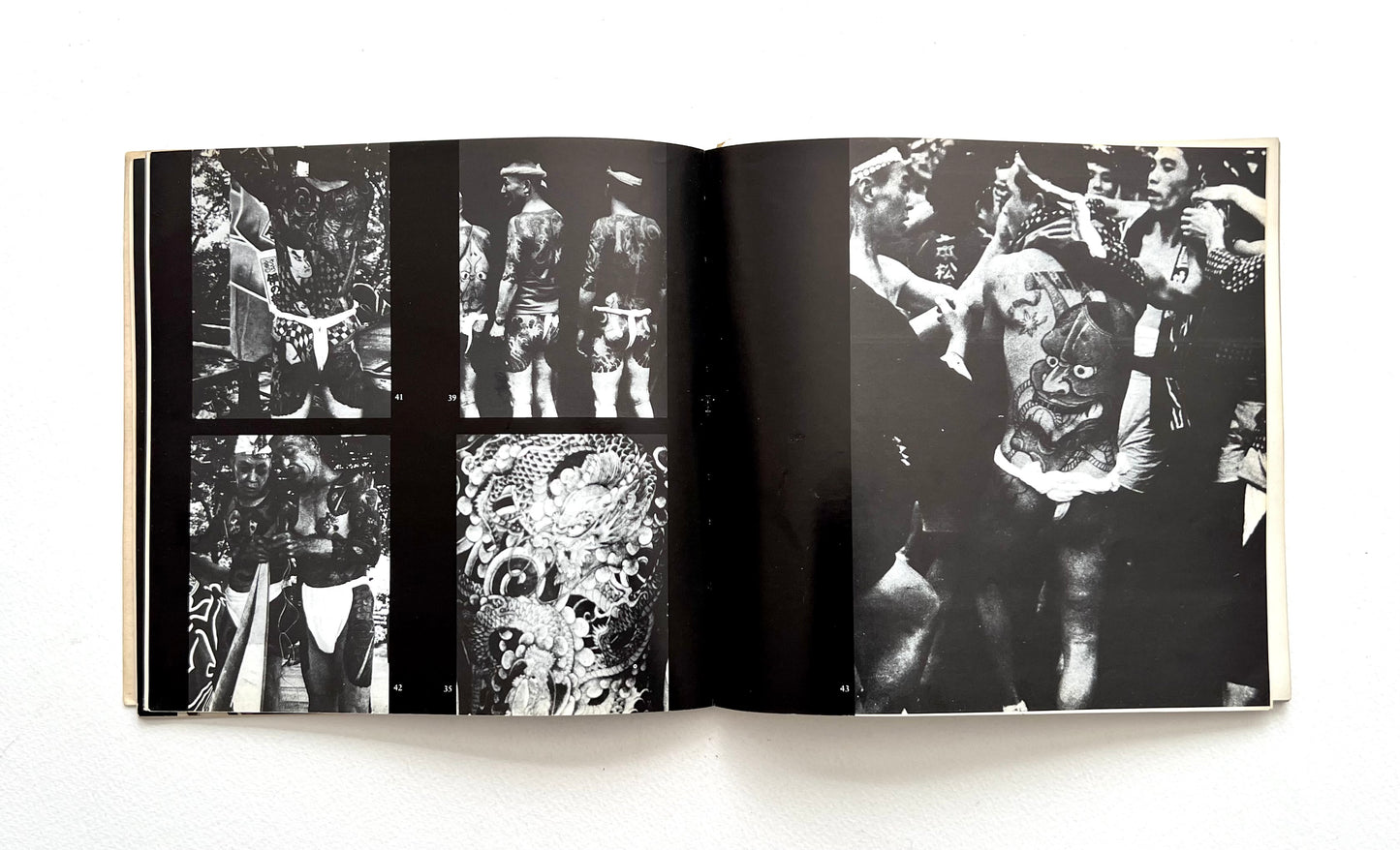 Open book displaying black and white photographs on a white background