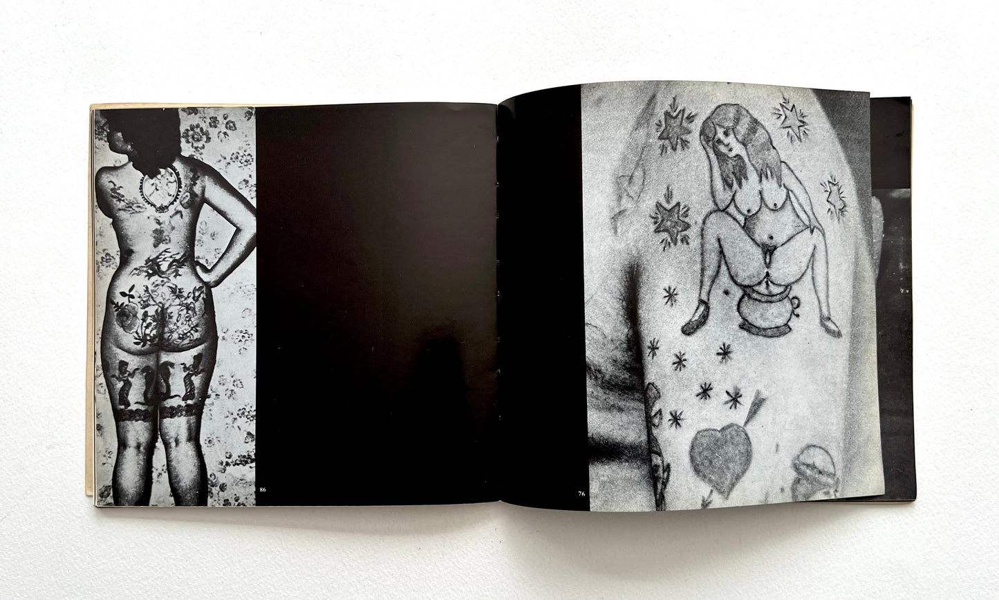 Open book displaying black and white illustrations of tattoos on a white background