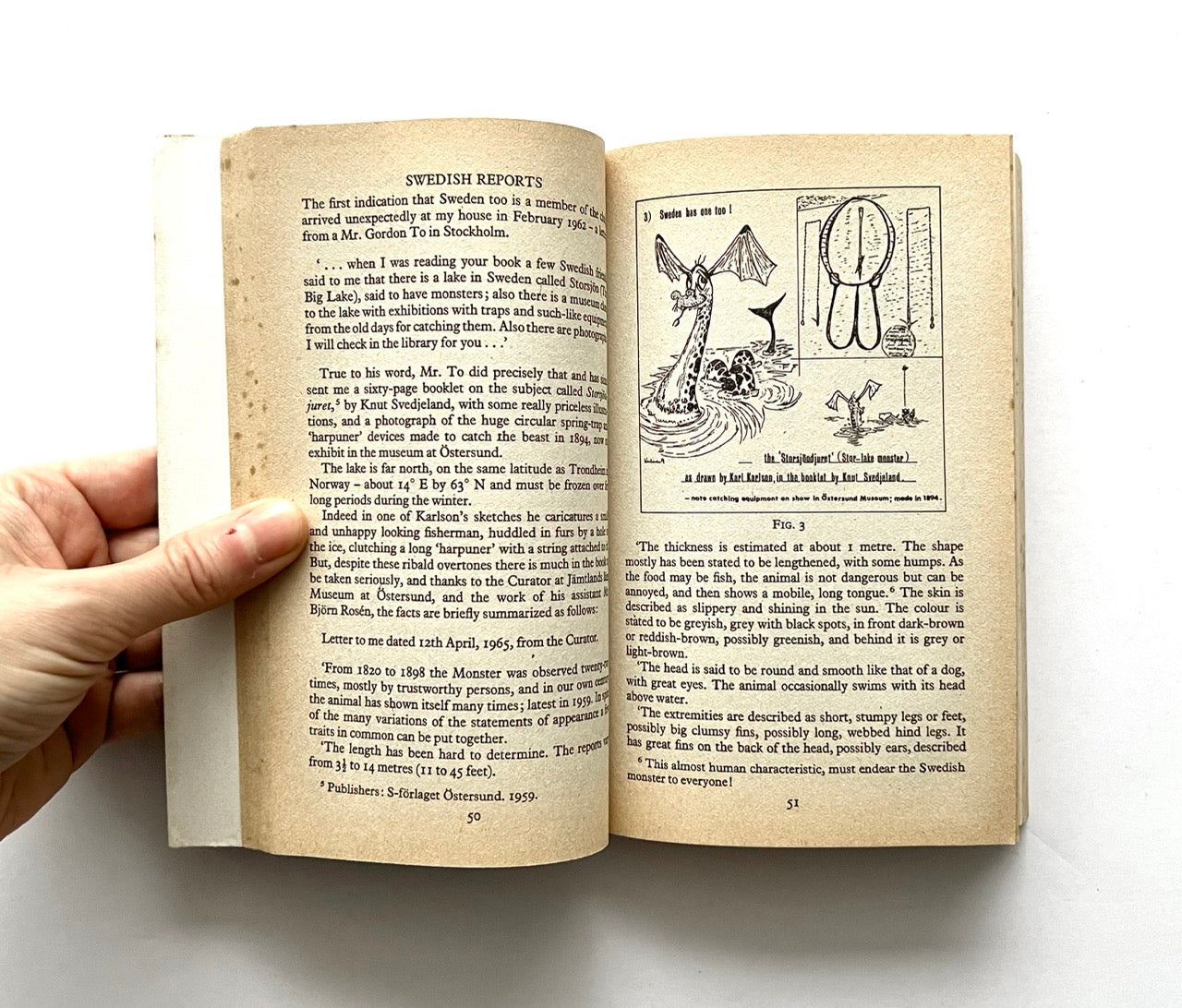 Open book, 'The Leviathans' by Tim Dinsdale, with drawing of sea monsters.