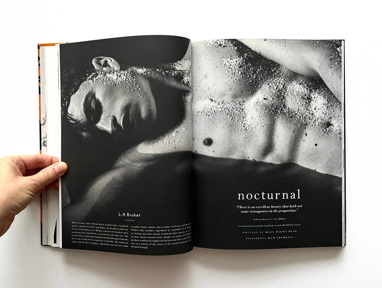 Open 'The Protagonist Magazine' issue 1, showing a black and white photograph of a naked man lying down in water with 'nocturnal' text.