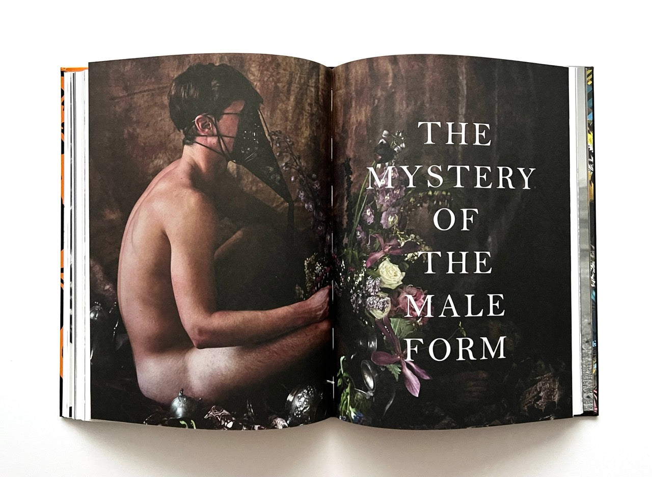 Open 'The Protagonist Magazine' issue 1, showing a naked man and floral design with 'The Mystery of the Male Form' text.