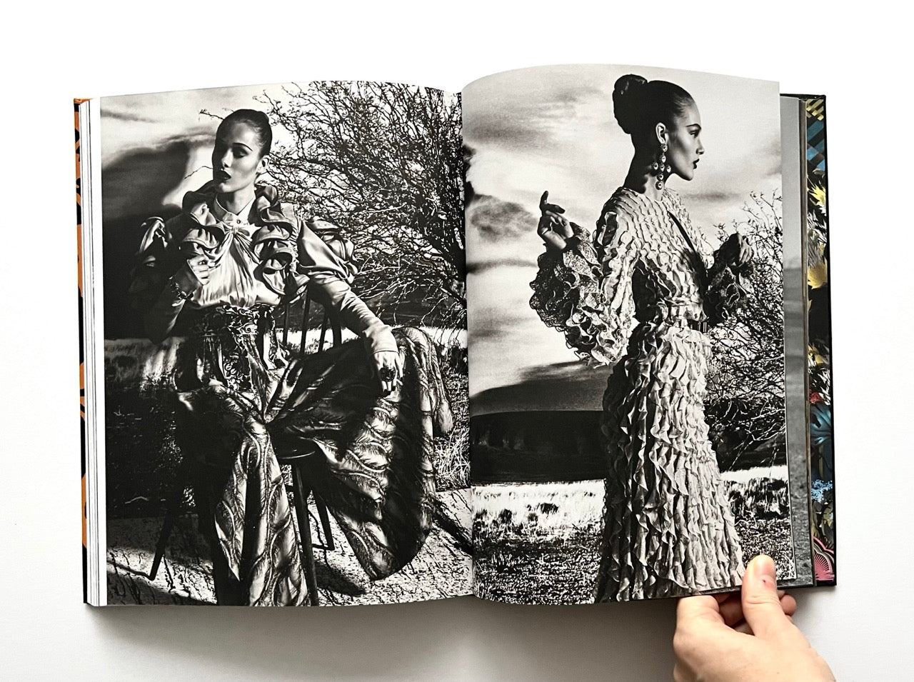 Open 'The Protagonist Magazine' issue 1, showing a black and white photo of a woman in a patterned dress against a scenic background.