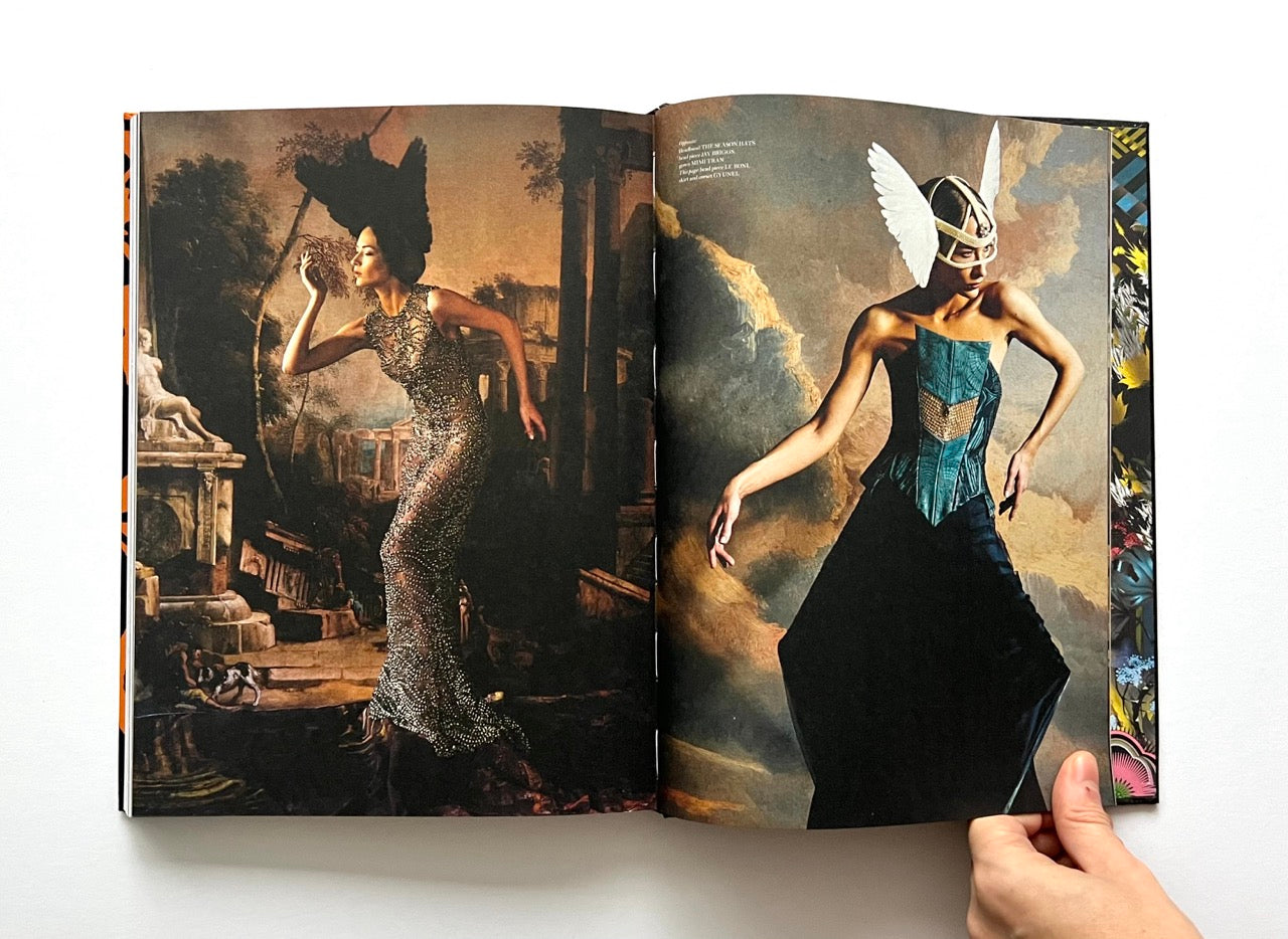 Open 'The Protagonist Magazine' issue 1, showing two fashion models in elaborate outfits against a classical painting background.