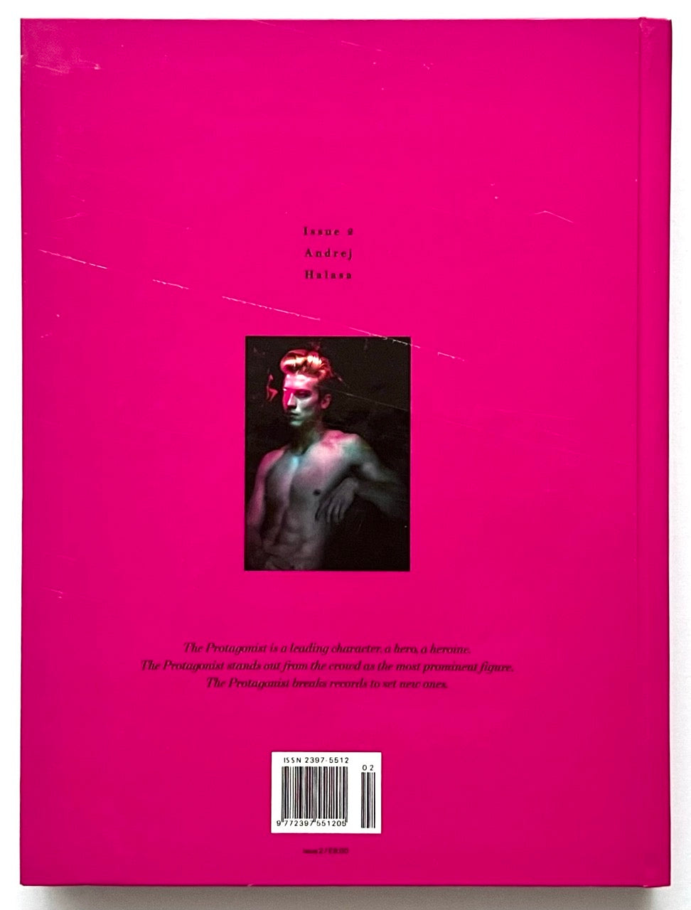 Pink rear cover of 'The Protagonist Magazine' issue 2, with a small photo of Andrej Halasa in the centre.