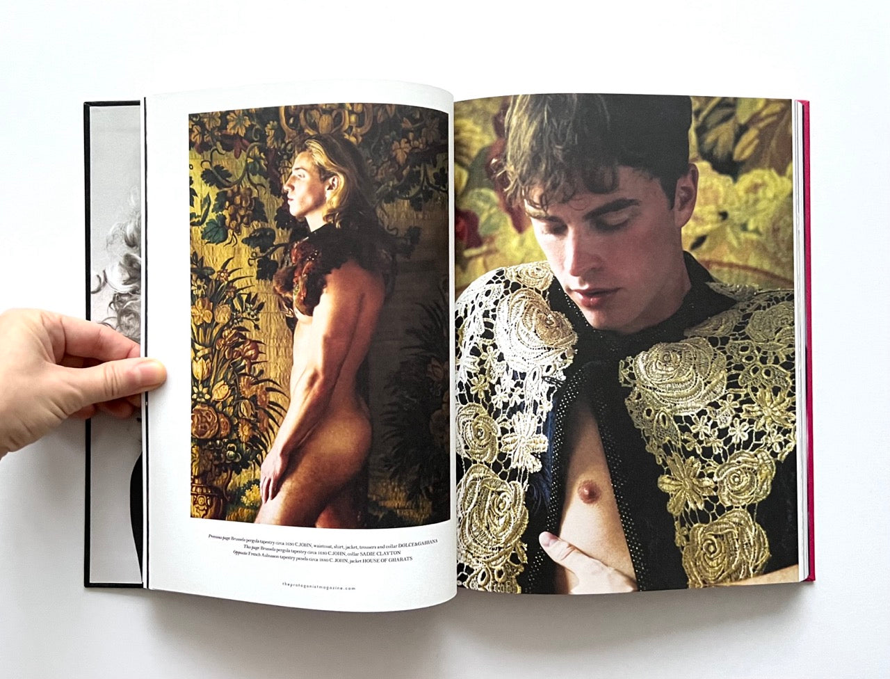 Open 'The Protagonist Magazine' issue 2, showing two pages with images of a man in ornate clothing and another, nude, in a natural setting.