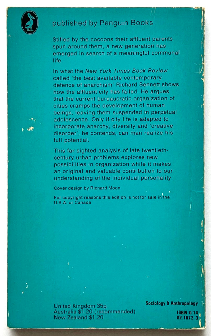Back cover of the Pelican paperback edition of The Uses of Disorder by Richard Sennett, featuring a turquoise background, black summary text about urban life and anarchism, publication details at the bottom, and visible scuffing and edge wear.