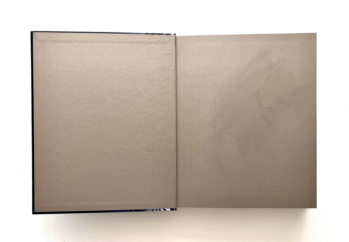 Open "World of Nobu" cookbook showing its bronze endpapers.