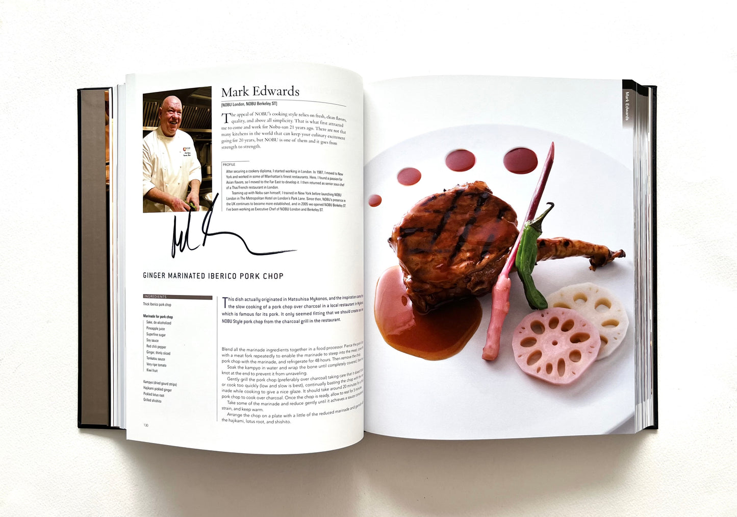 Open \World of Nobu' cookbook showing a page with a recipe for a marinated pork chop dish - signed by Mark Edwards.