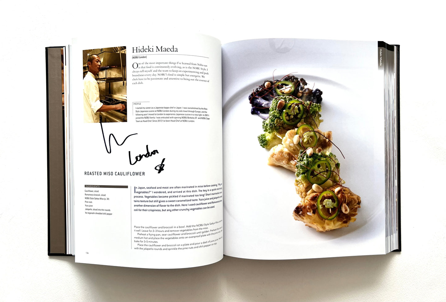 Open "World of Nobu" cookbook showing a recipet and a photograph of a ROASTED MISO CAULIFLOWER dish on a white plate - signed by chef Hideki Maeda.