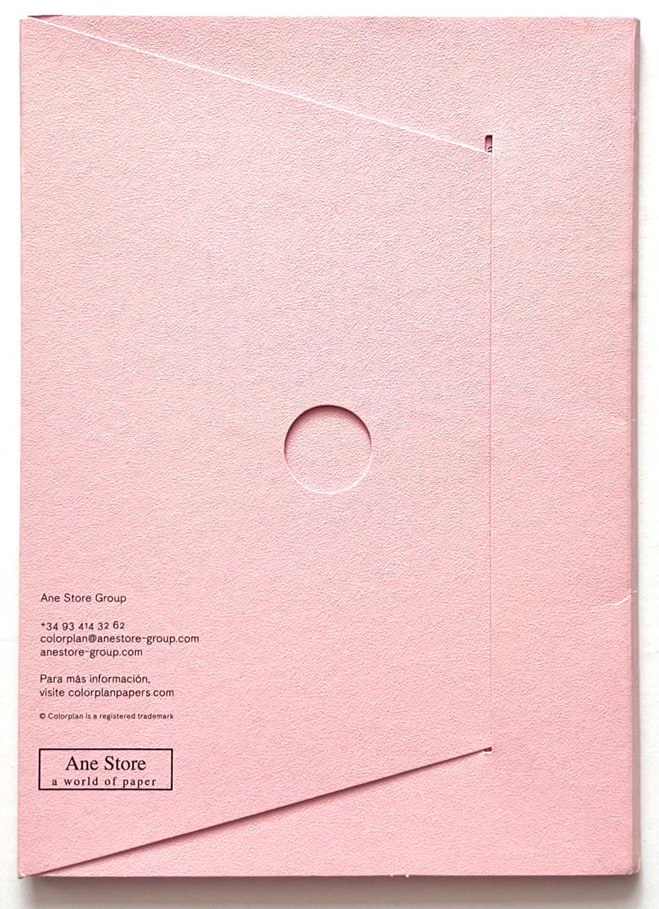 La Diferencia De Colorplan: Pura Innovación En Papel by Ane Store Group. Back cover of textured pale pink Colorplan paper portfolio with geometric folding design, embossed circular detail, and Ane Store branding.