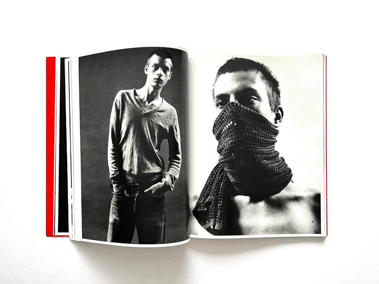 Interior spread of 10 Magazine Issue One featuring two studio portraits of a male model, one with a covered face
