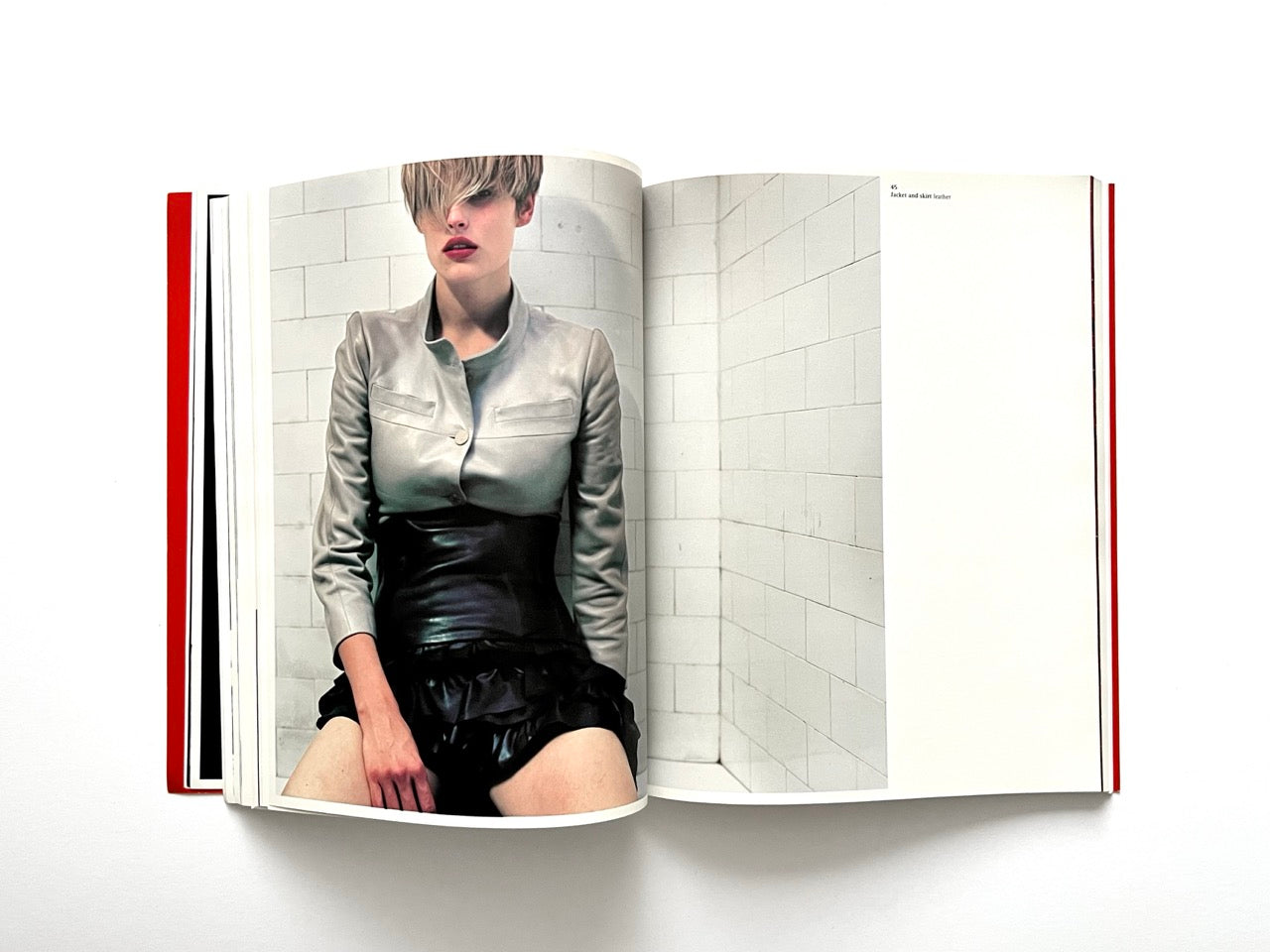 Interior spread of 10 Magazine Issue One featuring a model in a leather jacket seated against a tiled wall