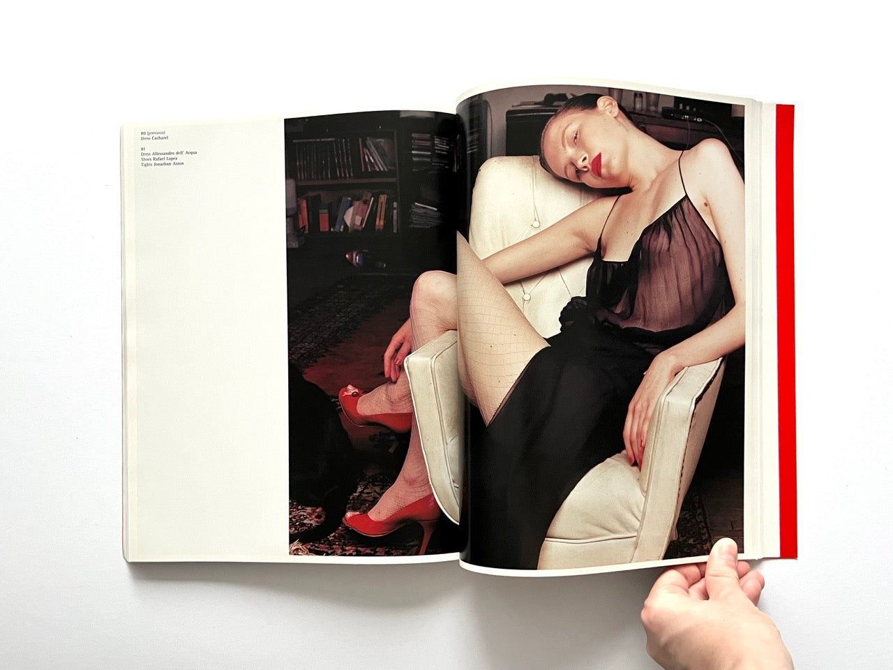 Interior spread of 10 Magazine Issue One featuring a model reclining in a chair wearing a sheer black dress and red heels