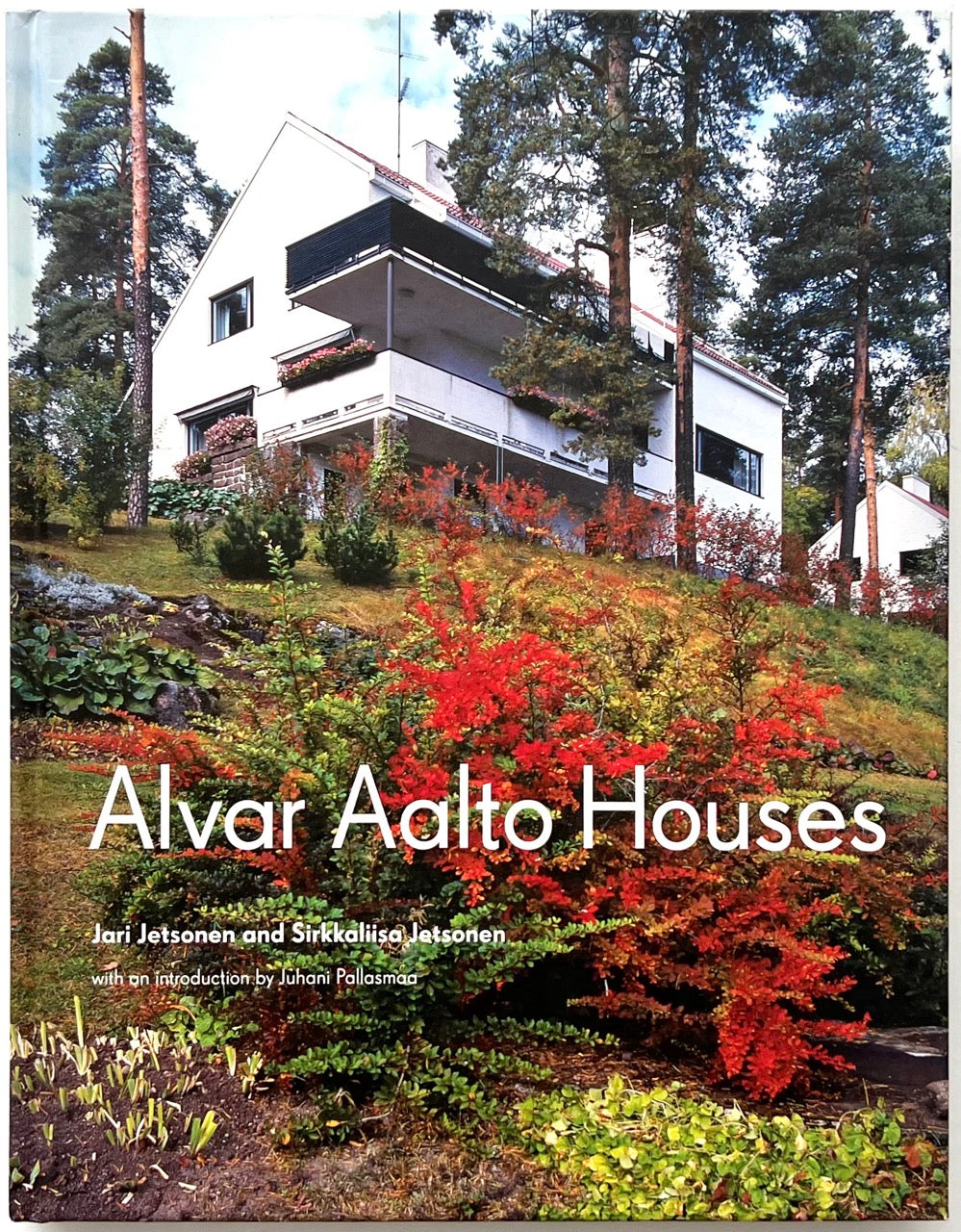 Front cover of Alvar Aalto Houses (2011) by Jari Jetsonen and Sirkkaliisa Jetsonen, featuring a modernist Alvar Aalto house nestled among pine trees with vibrant autumn foliage on a sloping landscape.