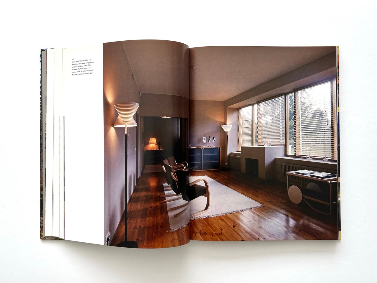 Interior spread from Alvar Aalto Houses (2011) by Jari Jetsonen and Sirkkaliisa Jetsonen, featuring a minimalist living room with Aalto furniture, timber flooring and large ribbon windows.
