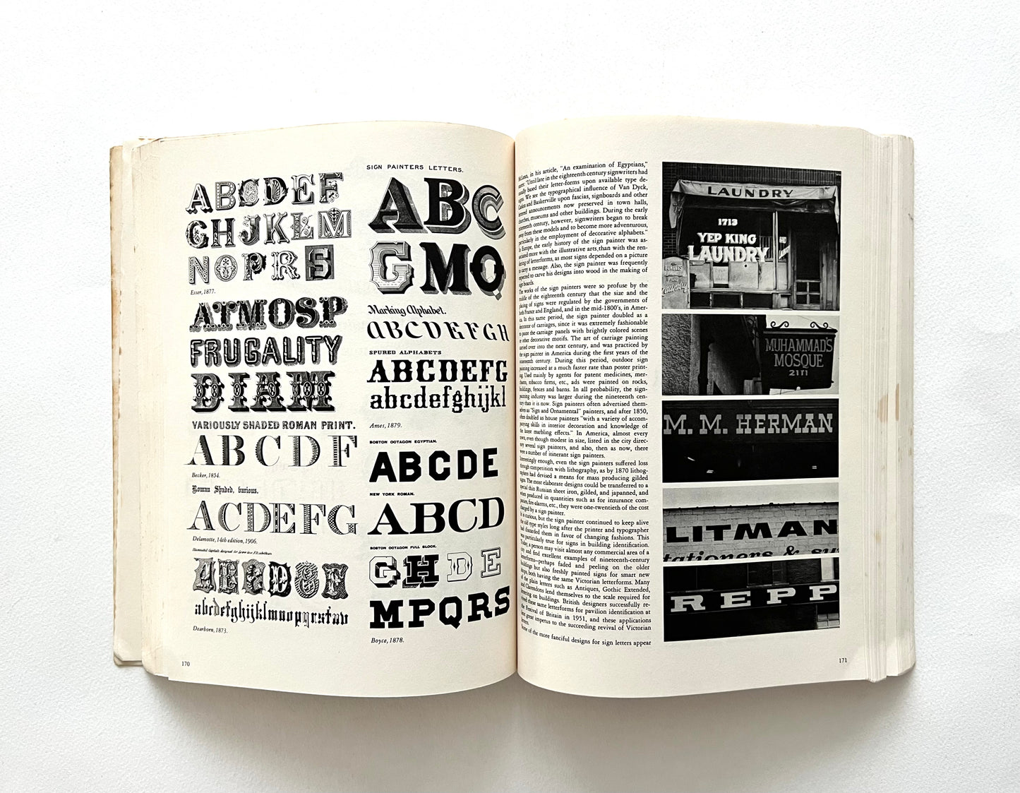 Open book displaying typographic designs and text on a white background