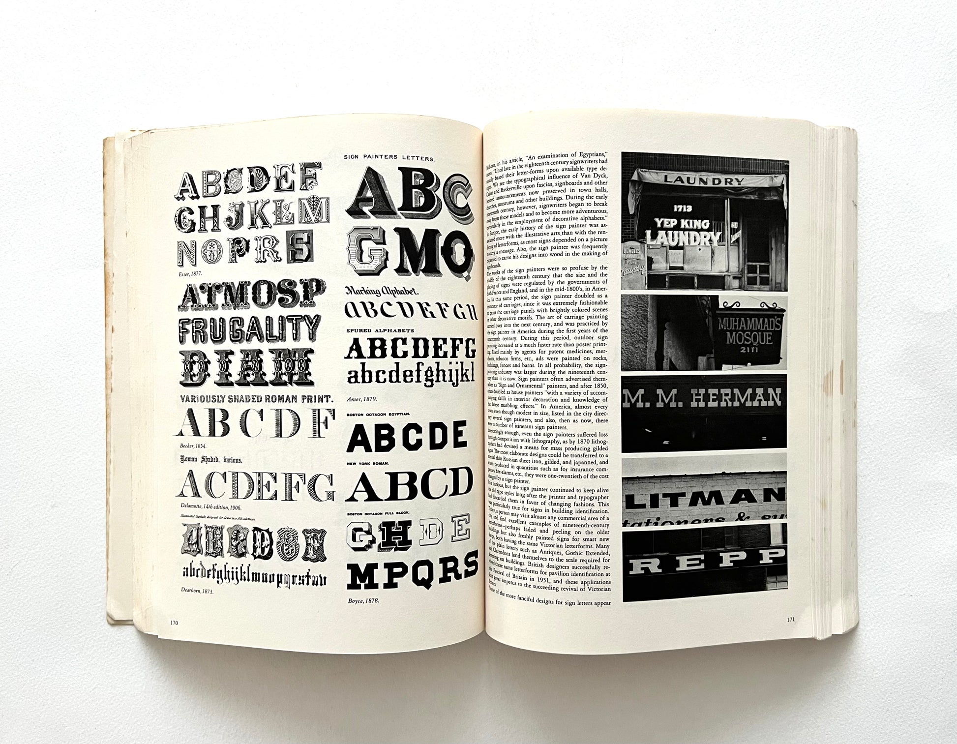 Open book displaying typographic designs and text on a white background