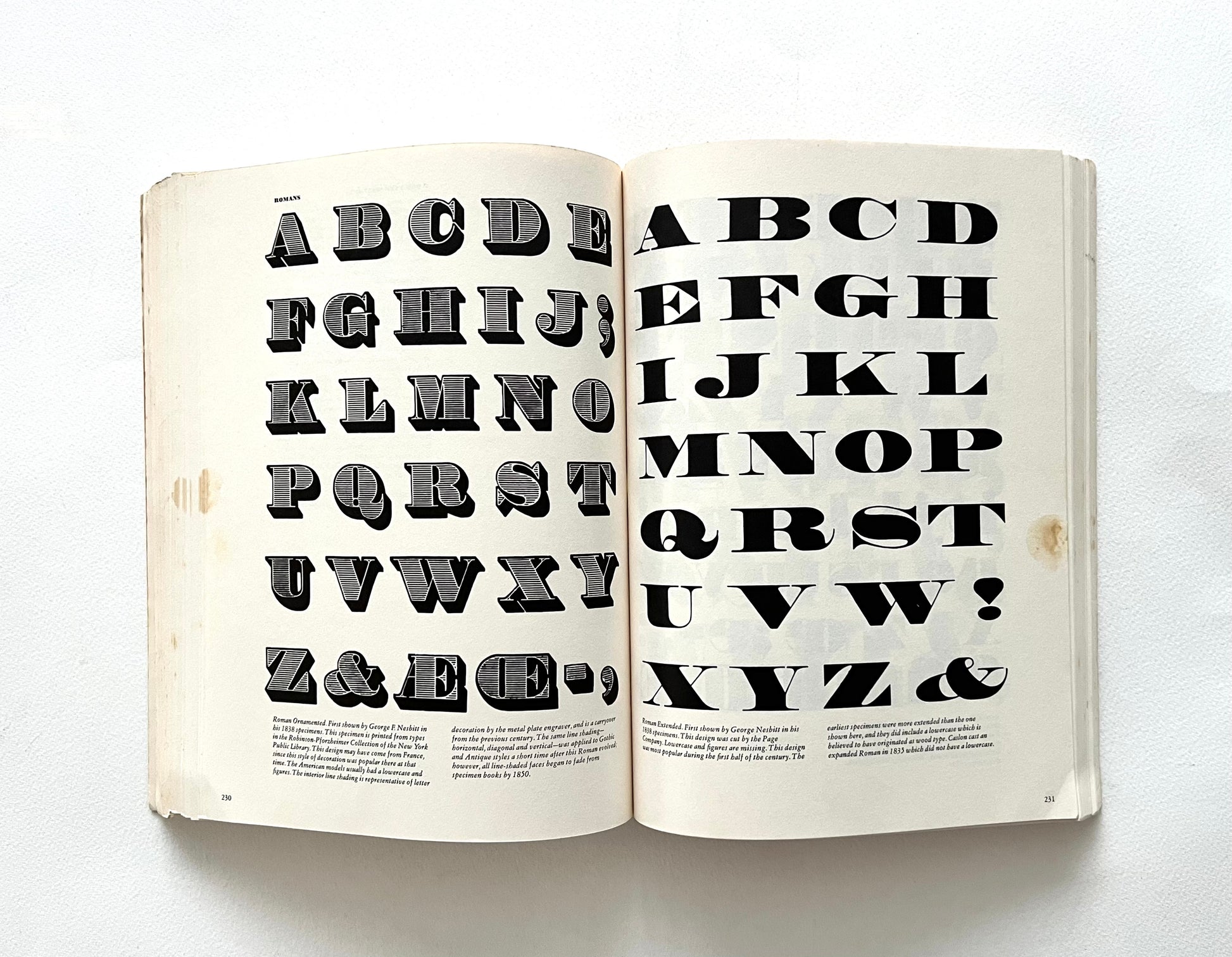 Open book displaying a typographic alphabet on a white background