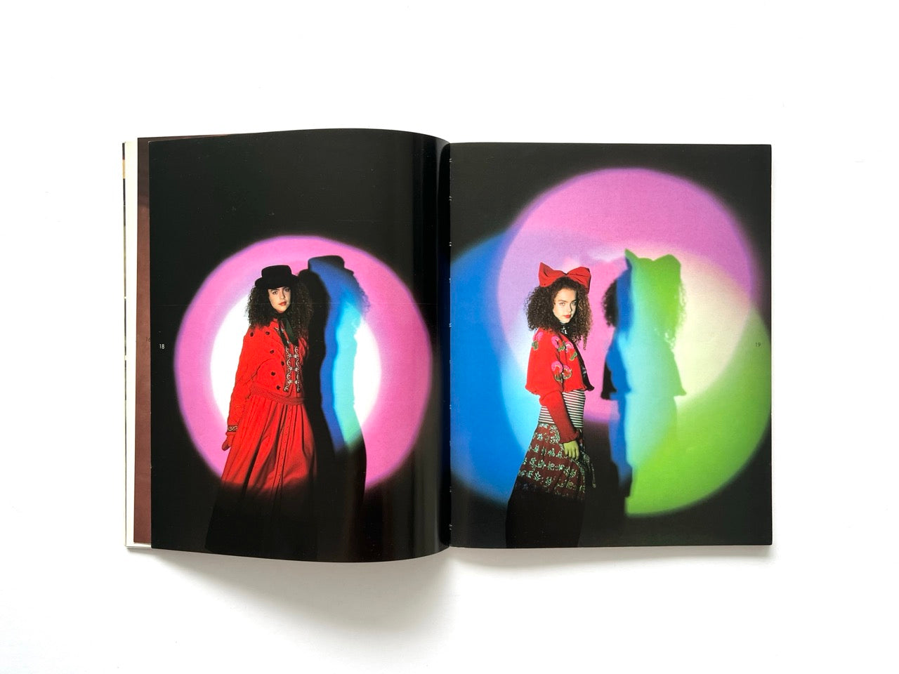 Interior spread from Atsuki Onishi's Knit Picture Book, published in 1989, showing vibrant studio fashion portraits with colourful spotlight effects highlighting knitwear collections.