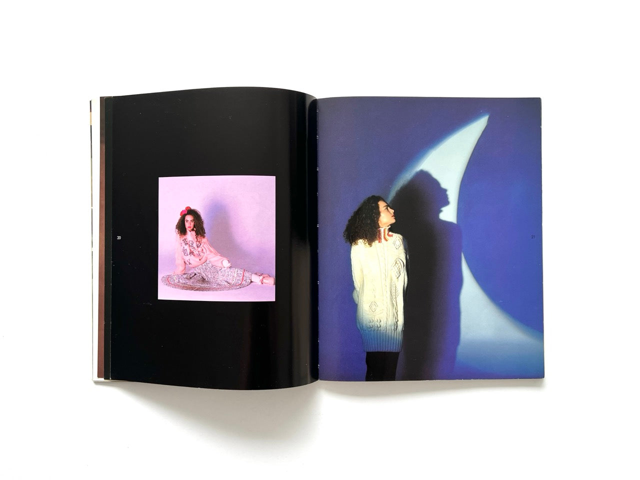Interior spread from Atsuki Onishi's Knit Picture Book, published in 1989, featuring dramatic studio portraits of models wearing oversized knit garments against star-shaped light projections.