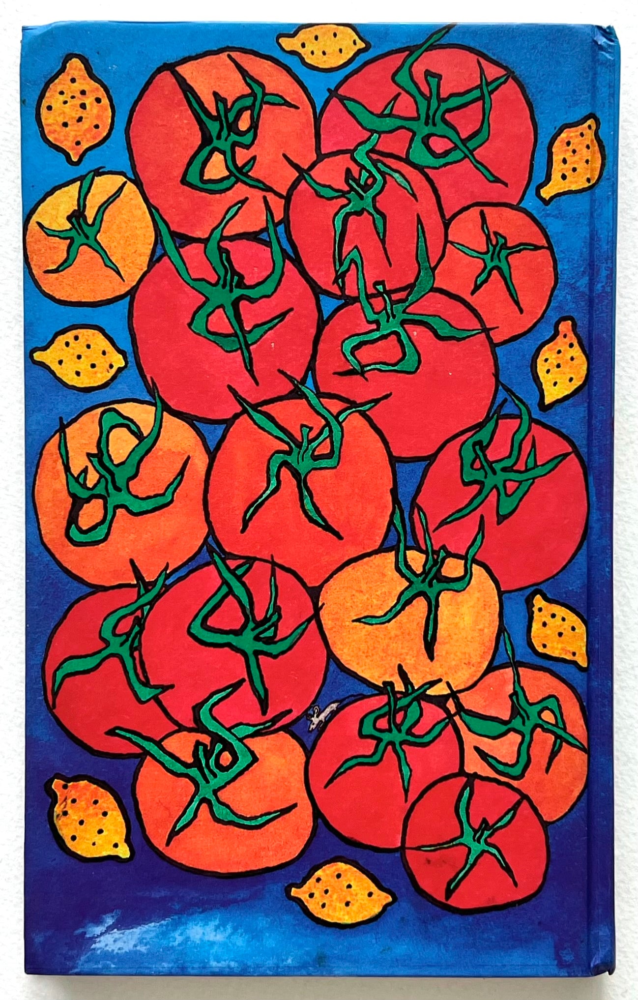 Rear cover of 'A La Pam' cookery book with a colourful image of  red and orange tomatoes and yellow lemons on a blue background.