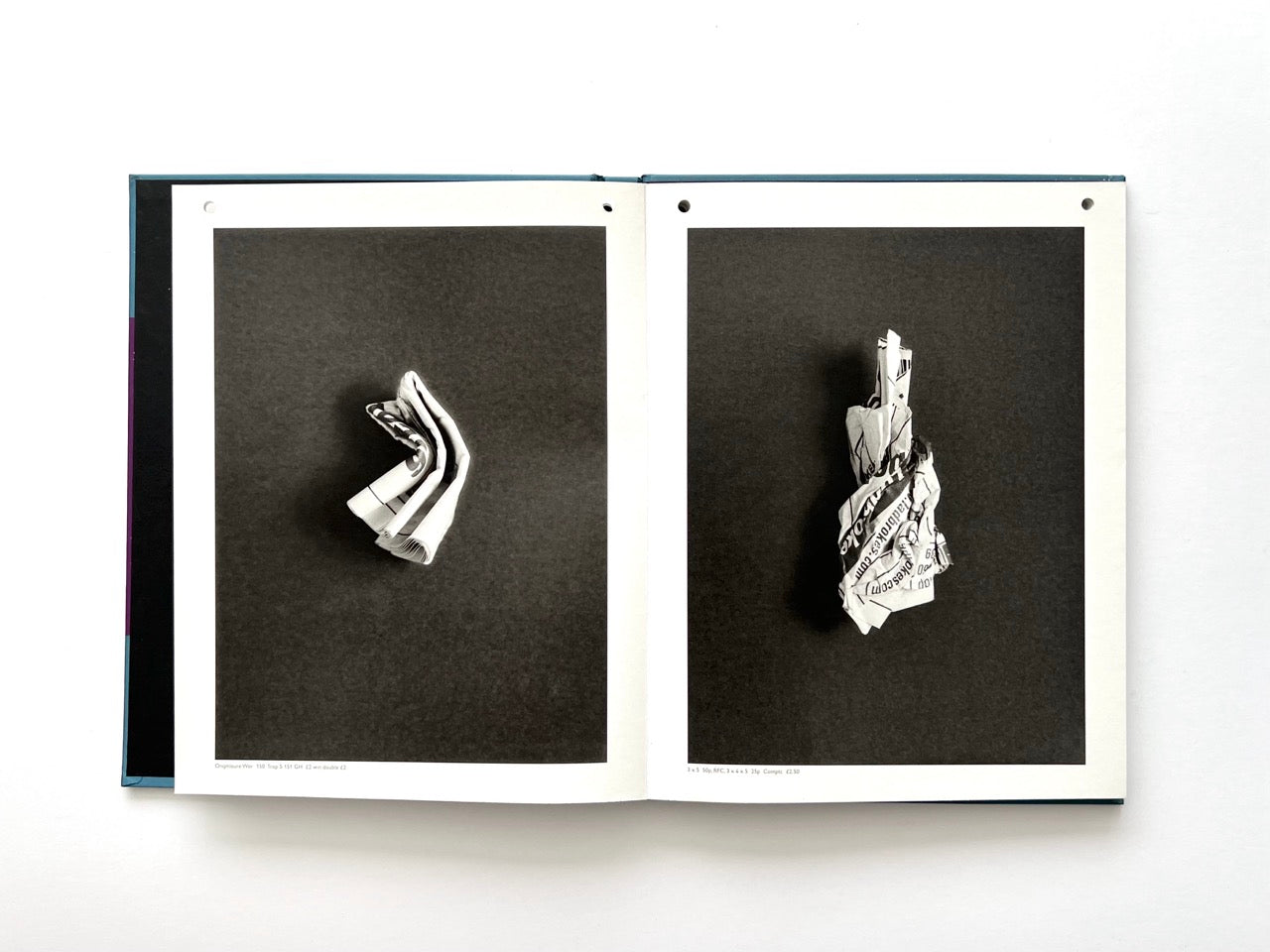 Interior spread from A Series of Disappointments (2008) by Stephen Gill, featuring two black-and-white photographs of folded and crumpled discarded betting slips against dark backgrounds.