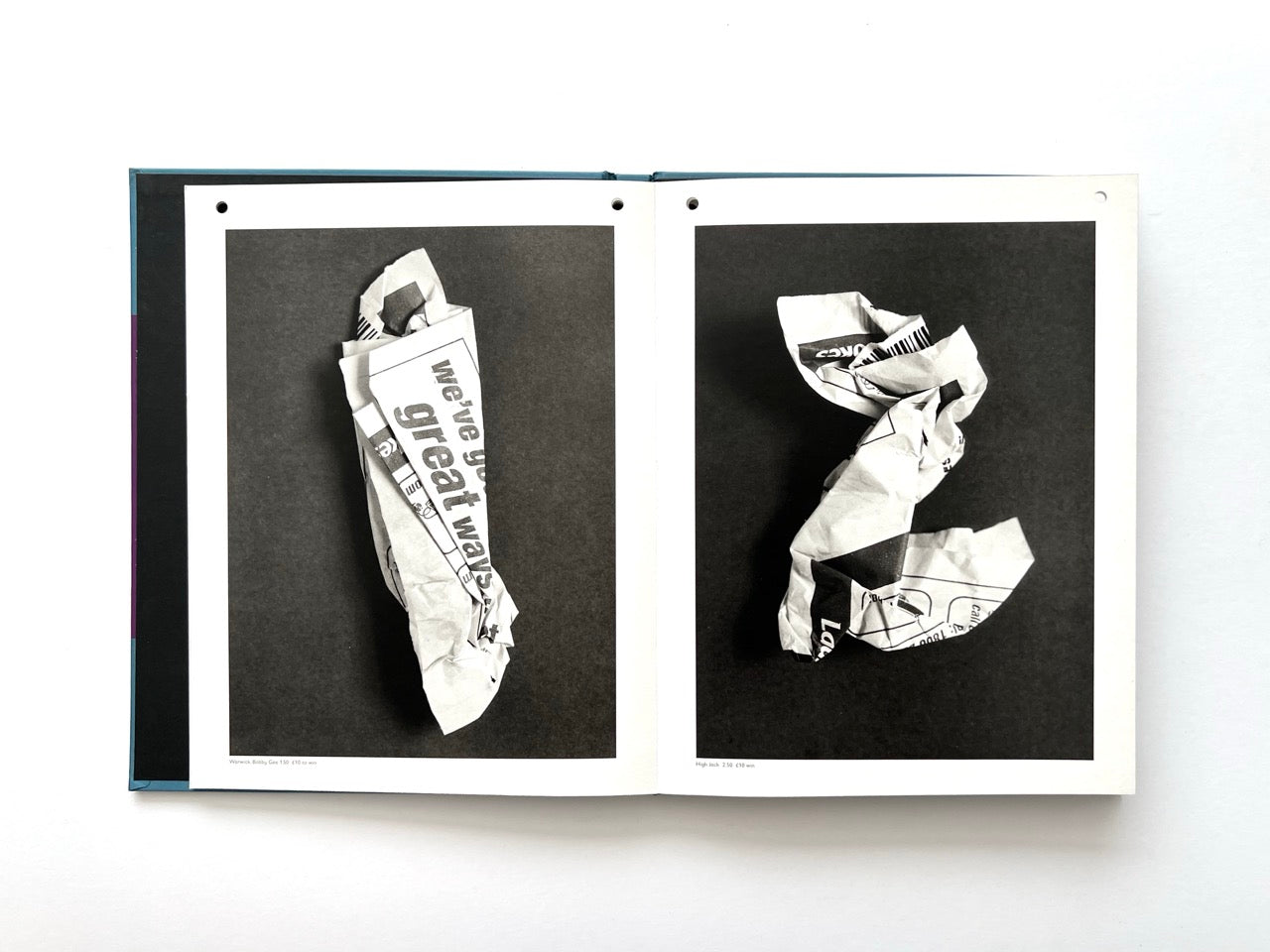 Interior spread from A Series of Disappointments (2008) by Stephen Gill, showing two sculptural forms made from crumpled betting slips, photographed in black and white against dark backgrounds.