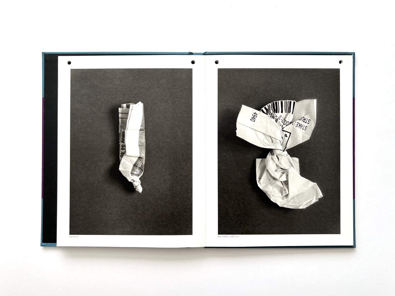 Interior spread from A Series of Disappointments (2008) by Stephen Gill, showing two crumpled betting slips with fragments of printed text and barcodes visible across their folded surfaces.