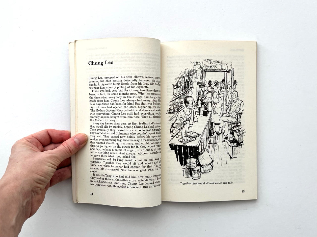 Interior spread from Backfire with short story text and line drawing of shop interior with seated figures