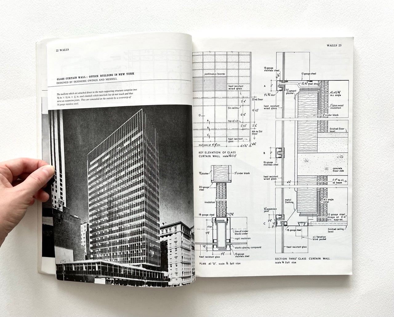 Open book - BEST OF ARCHITECTS’ WORKING DETAILS - VOLUME 1: EXTERNAL - showing b&w photograph of a modern office building and an architectural drawing.