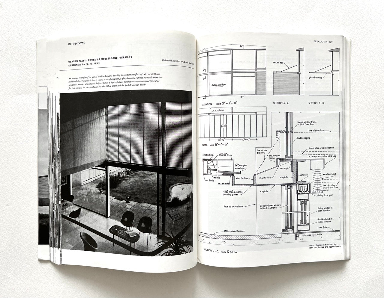 Open book - BEST OF ARCHITECTS’ WORKING DETAILS - VOLUME 1: EXTERNAL - showing b&w photograph of a minimalist modernist interior and an architectural drawing.