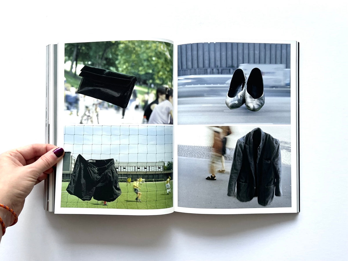 BLESS: Celebrating 10 Years of Themelessness by Désirée Heiss and Ines Kaag, 2006. Colour interior spread featuring a black handbag, shorts suspended on a sports-field fence, floating silver shoes and a black jacket photographed outdoors.