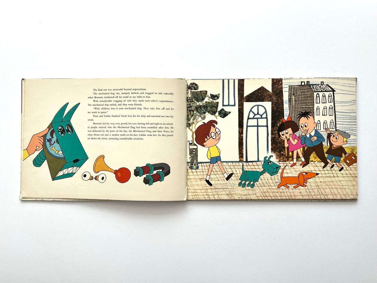 Brownie and the Mechanical Dog by György Várnai, 1976 – stylised illustration of mechanical dog components alongside children walking with both dogs in a city.