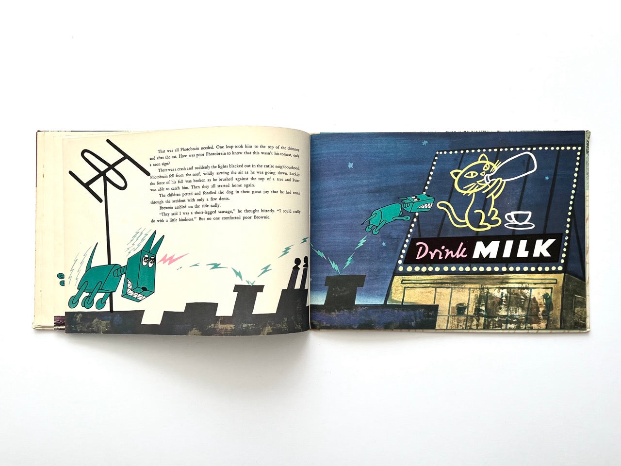 Brownie and the Mechanical Dog by György Várnai, 1976 – nighttime city scene with glowing “Drink Milk” billboard and mechanical dog leaping nearby.