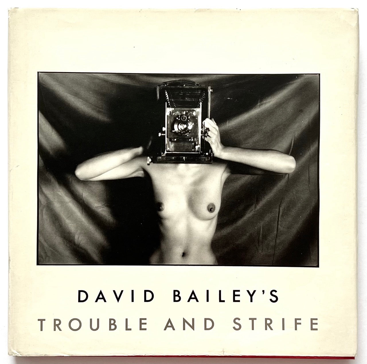 David Bailey’s Trouble and Strife, first edition published in 1980. Front cover of featuring black-and-white nude portrait with vintage camera obscuring the model’s face against a dark draped backdrop.