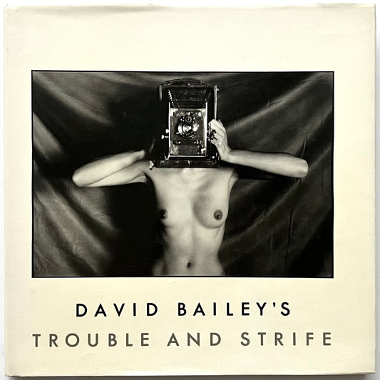 Book cover of 'David Bailey's Trouble and Strife' with a black and white photo of nude Marie Helvin holding a camera.