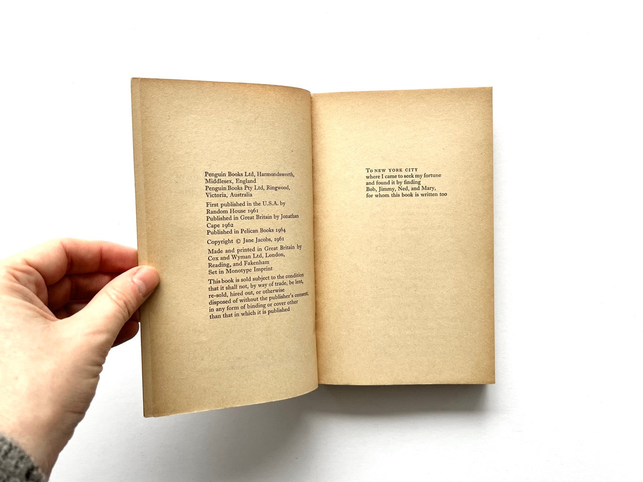 Copyright and dedication page spread of The Death and Life of Great American Cities by Jane Jacobs, showing yellowed paper, Penguin Books publication details on the left page, and a dedication to New York City on the right.
