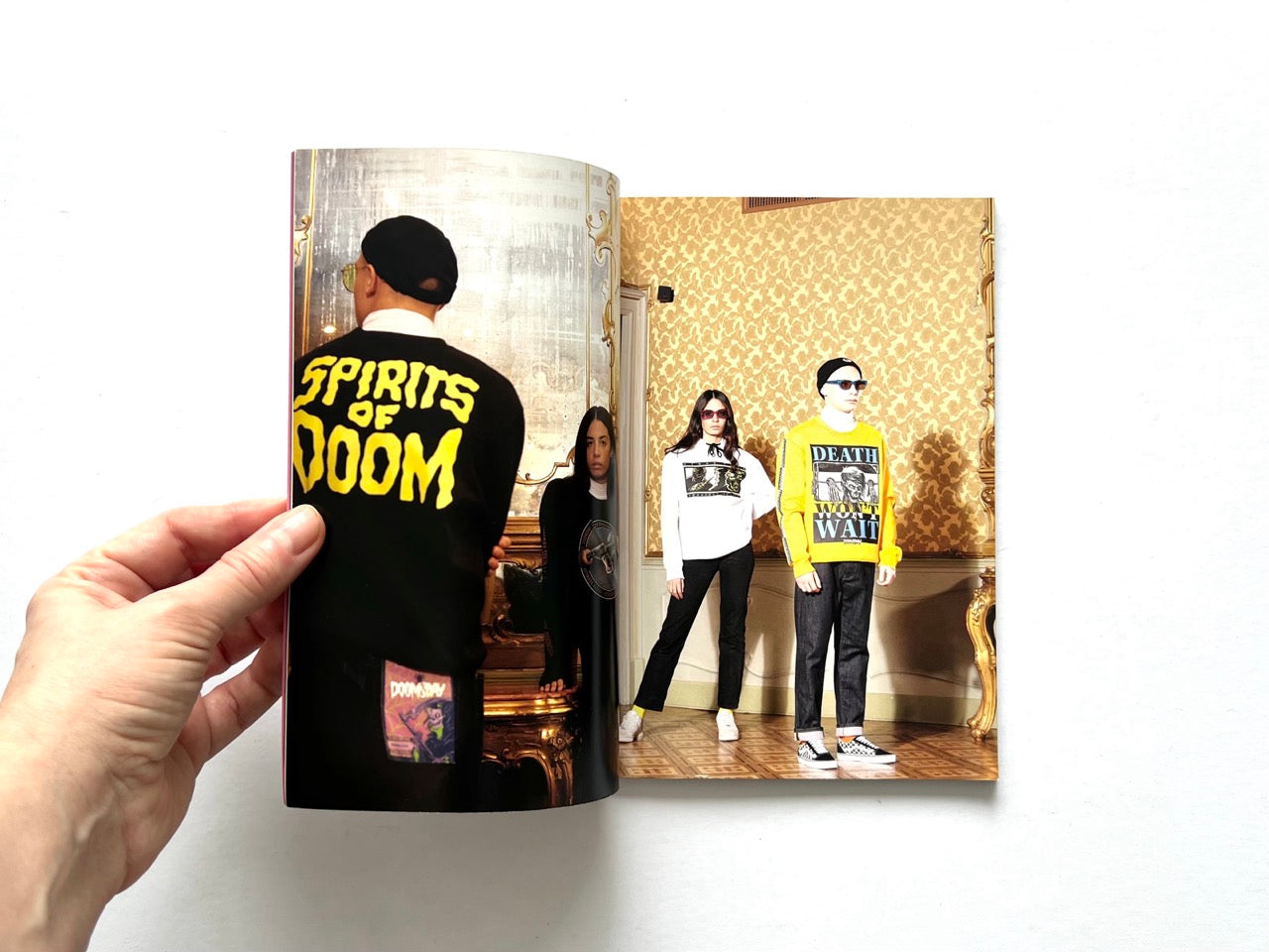 Doomsday Society Issue No. 01 – Interior spread showing models in graphic streetwear reading “Spirits of Doom” and “Death Won’t Wait” in an ornate, gold-toned interior.