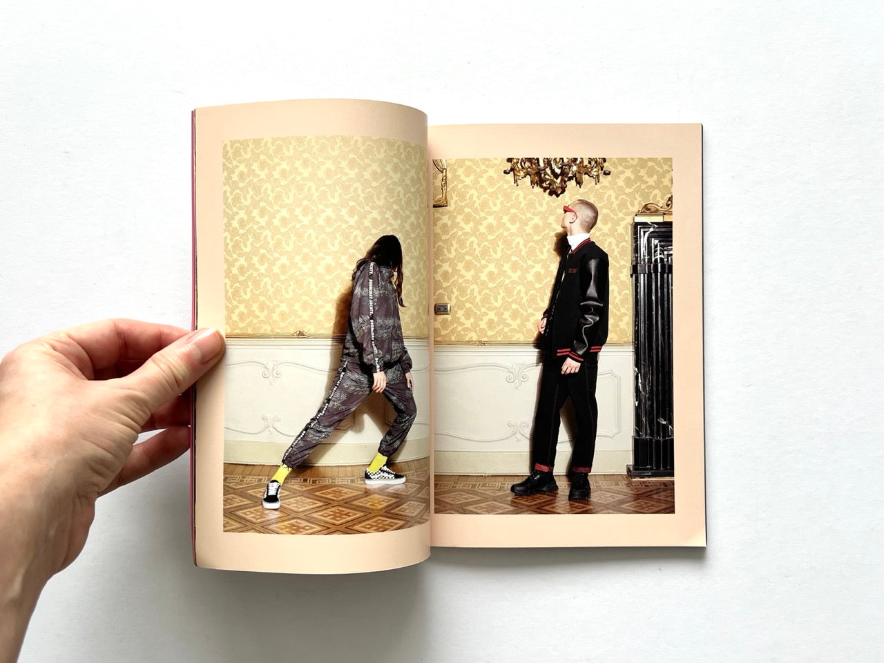 Doomsday Society Issue No. 01 – Interior spread showing two models posed against patterned wallpaper, wearing coordinated tracksuits and streetwear.