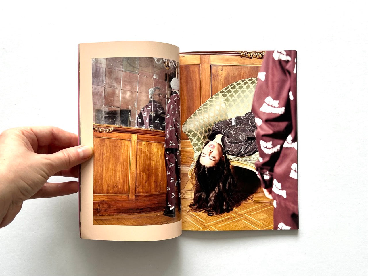 Doomsday Society Issue No. 01 – Interior spread with a model reclining upside down on a chair,and another one  reflected in aged mirror panels within a richly detailed interior.