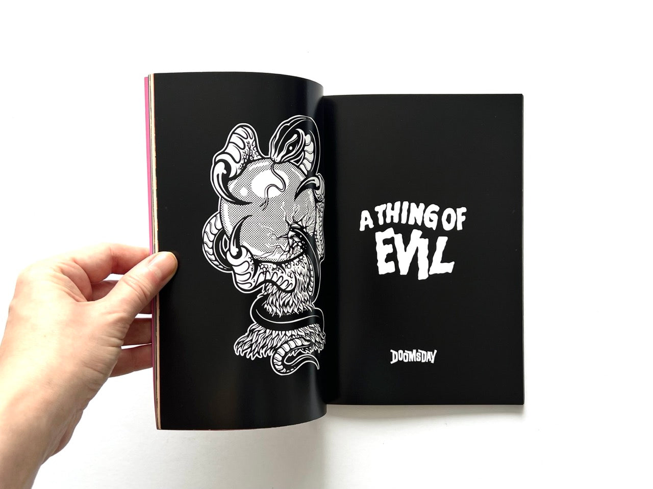 Doomsday Society Issue No. 01 – Interior spread featuring black background with illustrated horned figure and text reading “A Thing of Evil”.