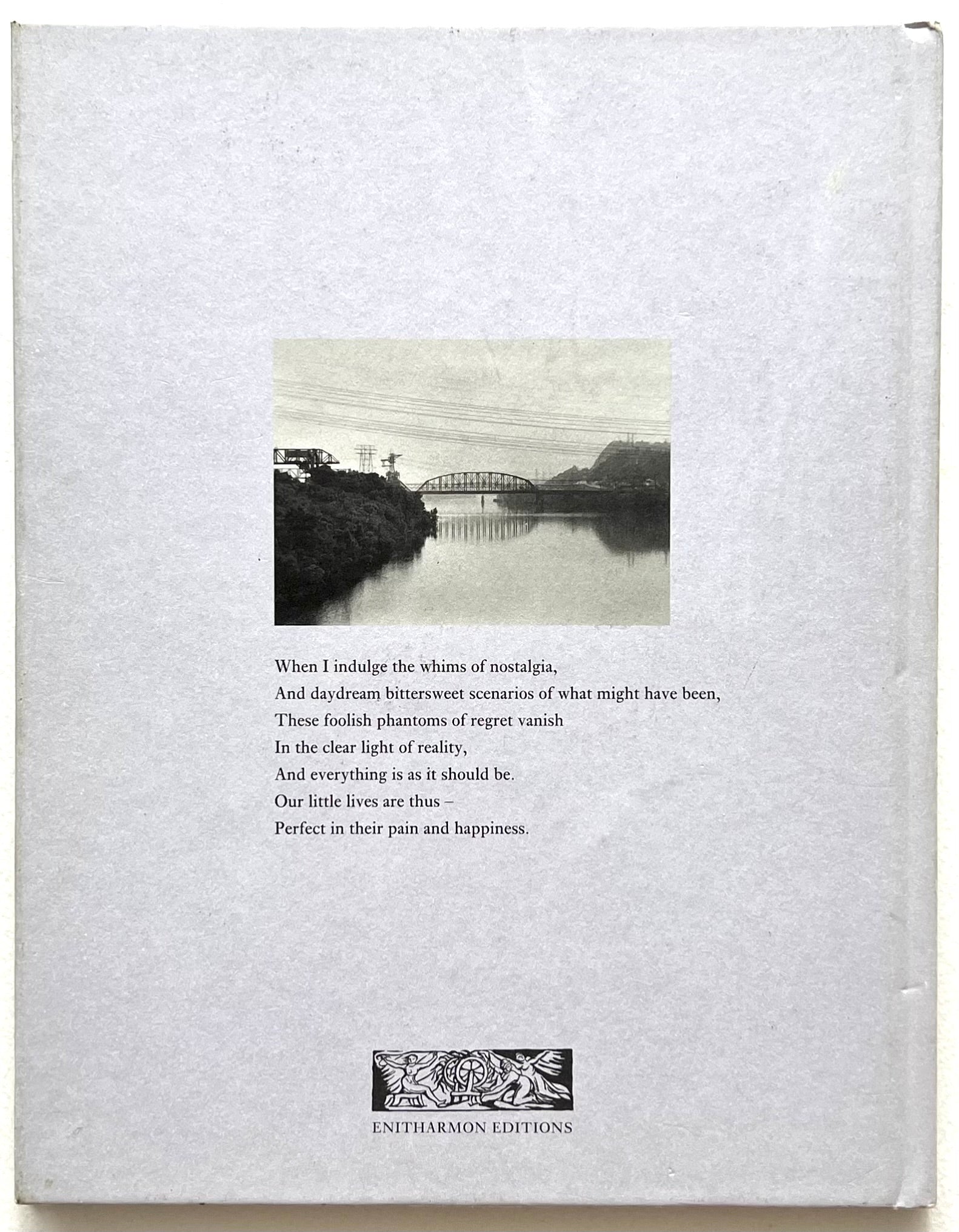 Rear book cover of "The House I Once Called Home' by Daune Michals, with black and white photograph of a bridge over water and text.