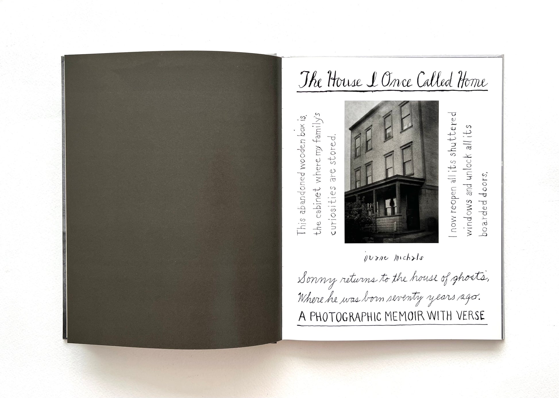 Open book showing a title page of 'The House I Once Called Home' by Duane Michals, with black and white text and a photograph of a house on a white background
