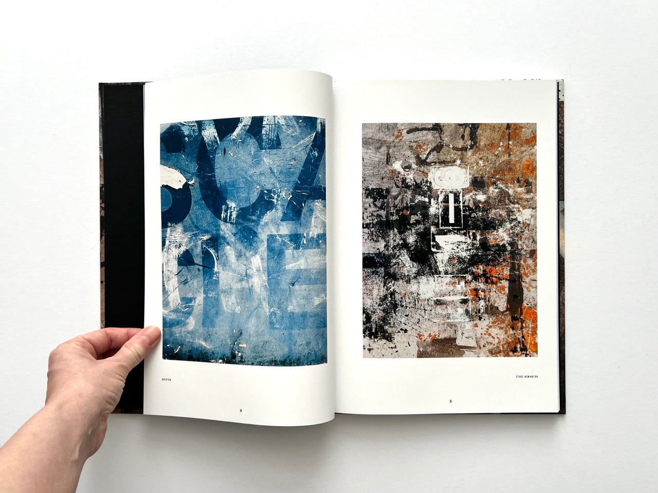 Interior spread from Dubious Splendor: Graphic Works by Rob Sanders 2023–2024 showing blue-toned abstraction and textured mixed-media composition